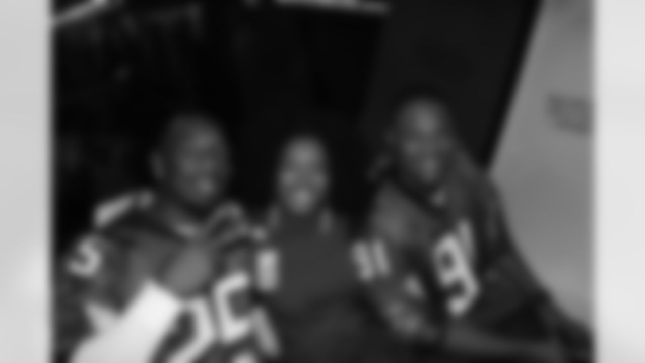 Several Falcons traded places with AirTran workers to marshal planes, take tickets and greet passengers // Trading Places - AirTran // Nov. 1, 2011 // Atlanta -