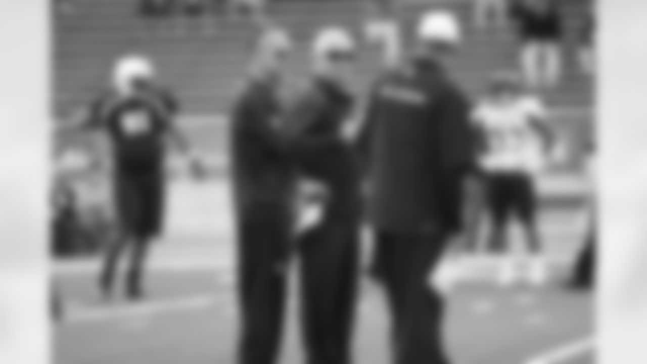 Head coach Mike Smith (middle), defensive coordinator Mike Nolan (left), and Glenn Pires chat during practice.