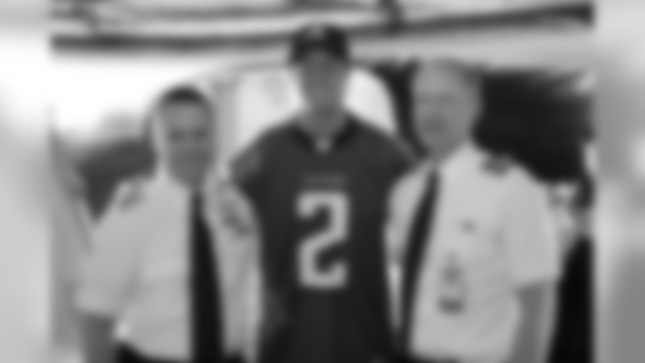 Several Falcons traded places with AirTran workers to marshal planes, take tickets and greet passengers // Trading Places - AirTran // Nov. 1, 2011 // Atlanta -