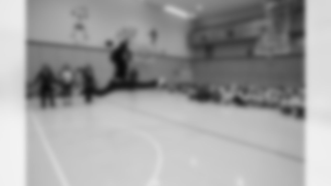 Alice F. and other NFL Cheerleaders visit an elementary school while on their trip