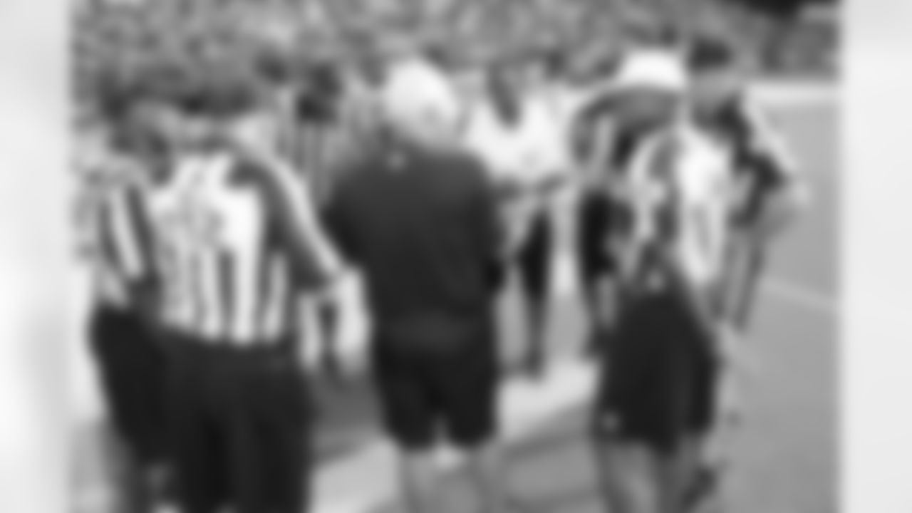 Head coach Mike Smith talks to the referees