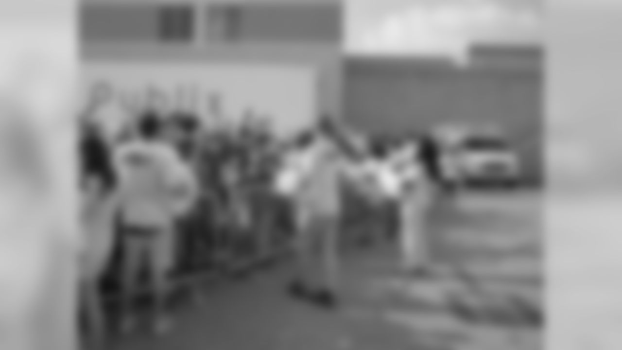 Fans clamor for giveaway towels before the gates open. // 2011 Friday Night Lights // August 5, 2011 // Norcross, Ga. —