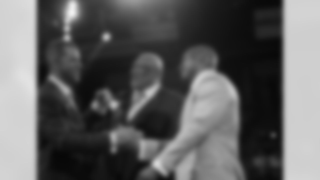 Pro Football Hall of Fame Class of 2014 members Andre Reed, Derrick Brooks and Claude Humphrey greet each other on stage at the jacket ceremony