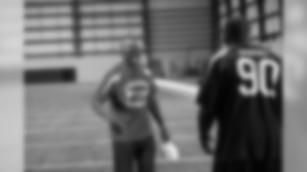 Lawrence Sidbury and defensive line coach Ray Hamilton laugh after they complete a game as the Falcons linemen participated in Lineman Olympics with Georgia Power linemen Thursday for video features throughout the season in the Georgia Dome // Georgia Pow
