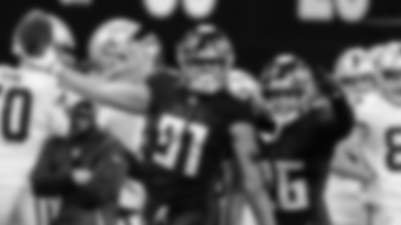 Atlanta Falcons defensive tackle Jacob Tuioti-Mariner #91 celebrates with cornerback Isaiah Oliver #26 after Tuioti-Mariner caused a fumble during the second quarter against the Las Vegas Raiders on November 29, 2020.