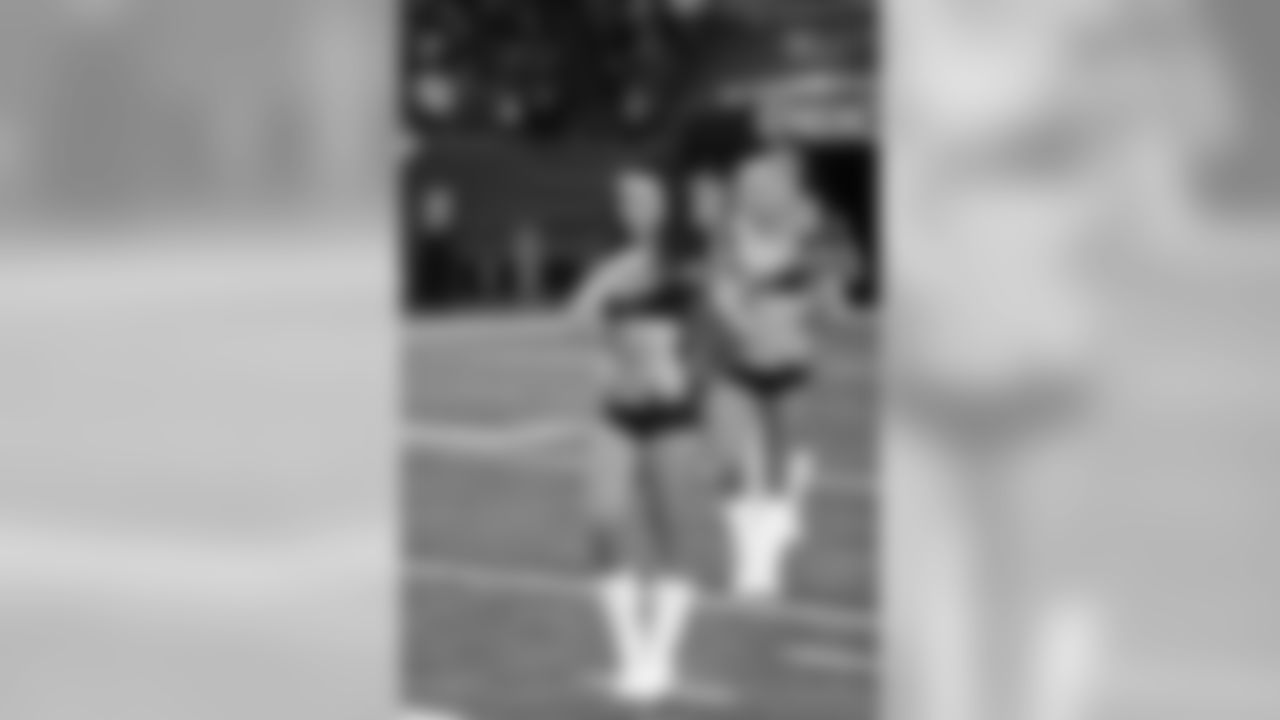 Natalie S. and the rest of the Atlanta Falcons Cheerleaders pause for the National Anthem