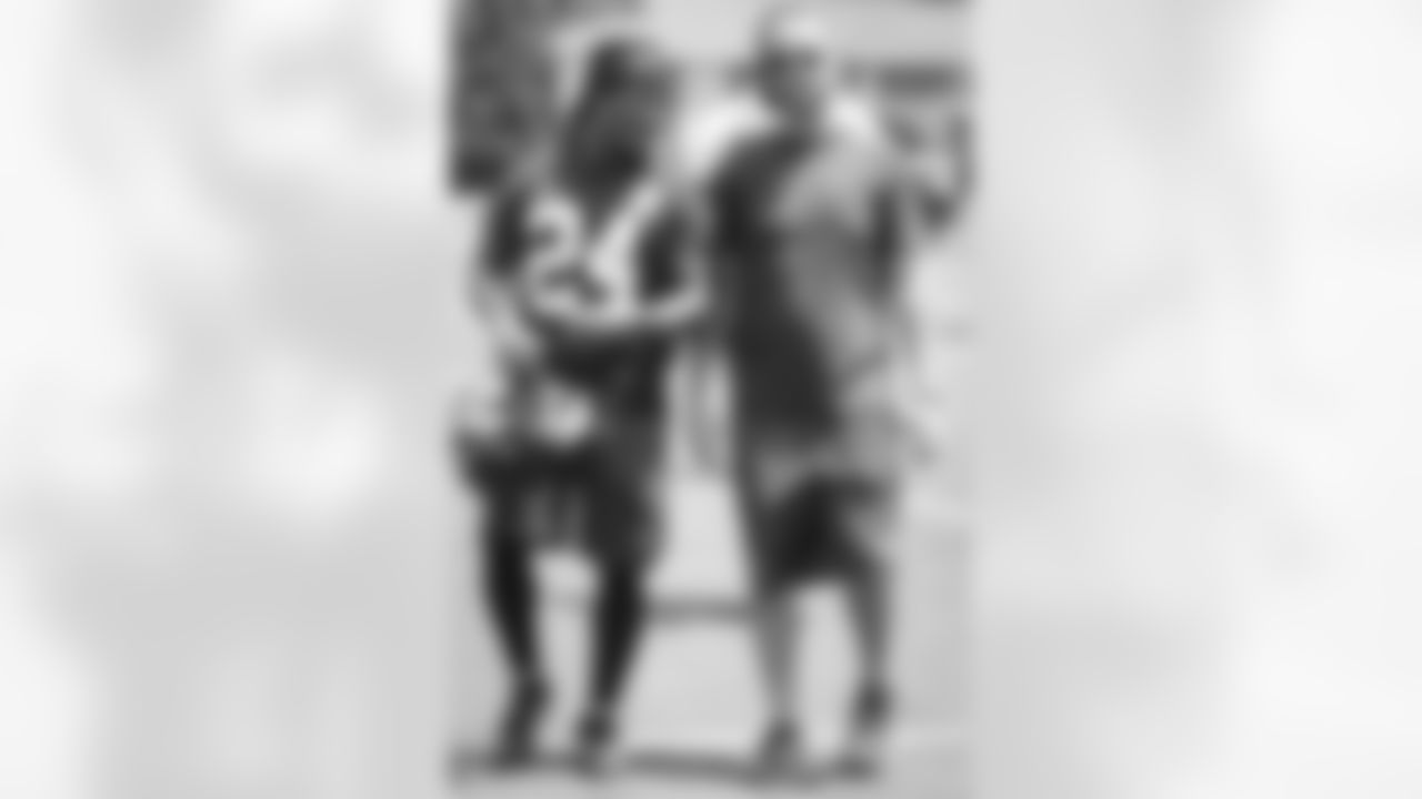 RB Devonta Freeman walks off the field with Brian Cearns