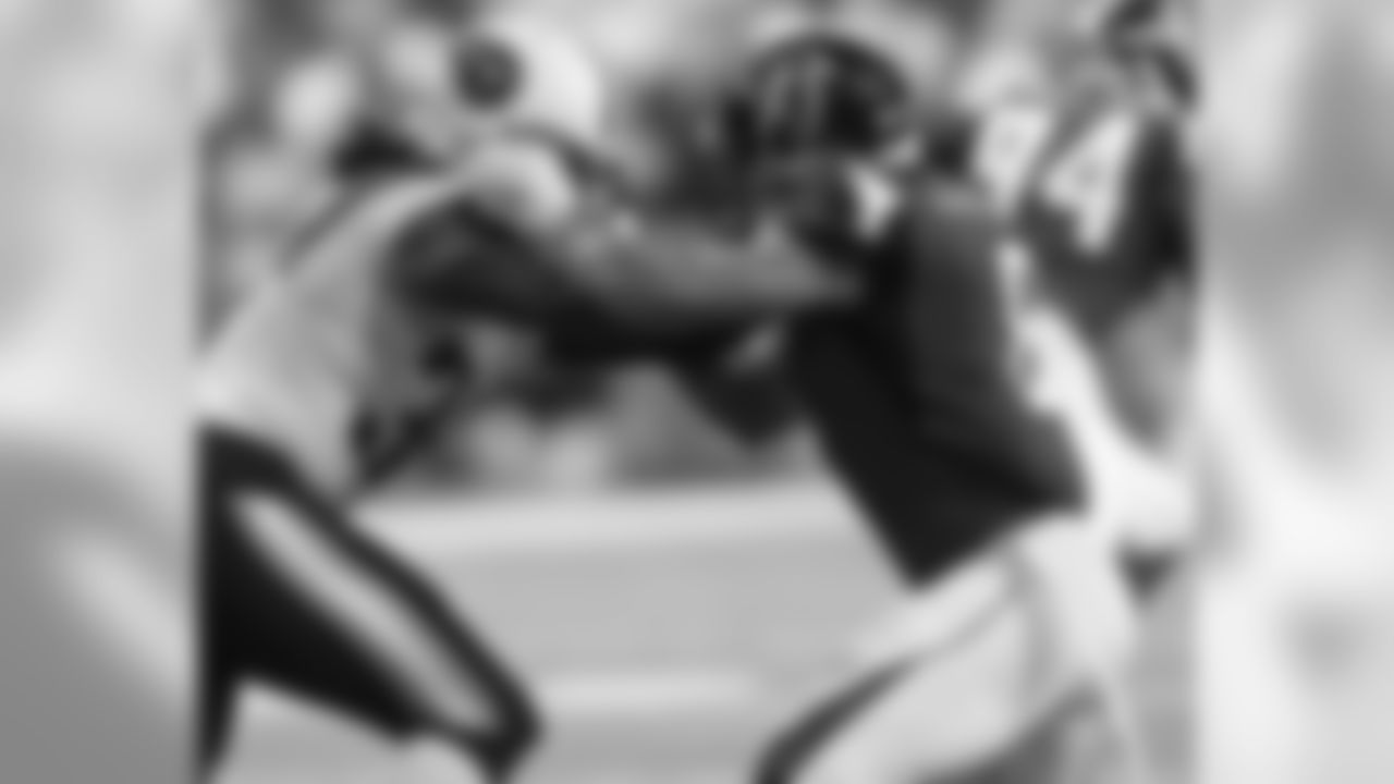WR Eric Weems attempts to fight past a Titans' player.