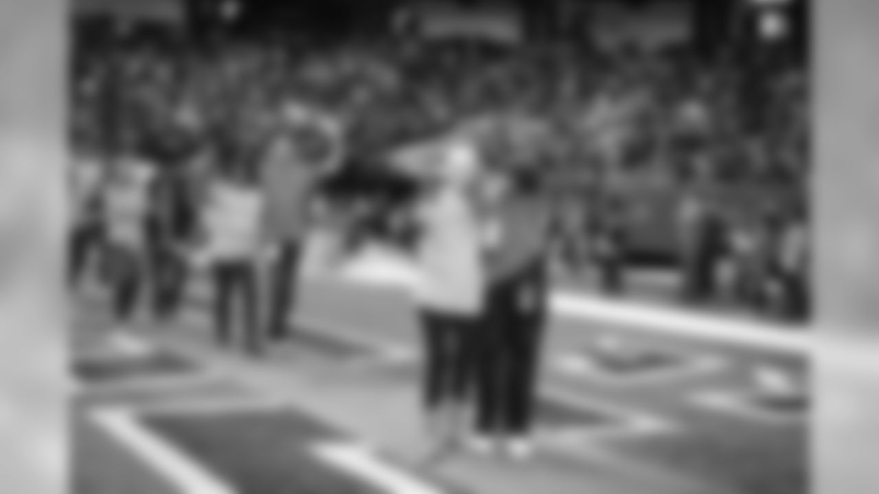Breast cancer survivors received pink roses and were escorted out of the tunnel onto the field by Falcons alumni