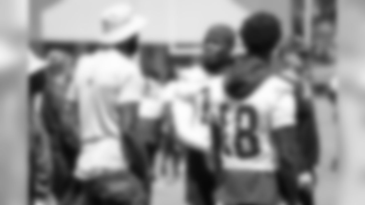 Former NFL wide receiver Calvin Johnson talks to WR Mohamed Sanu
