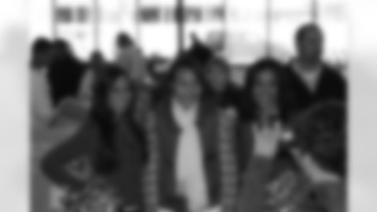 Several Falcons traded places with AirTran workers to marshal planes, take tickets and greet passengers // Trading Places - AirTran // Nov. 1, 2011 // Atlanta -