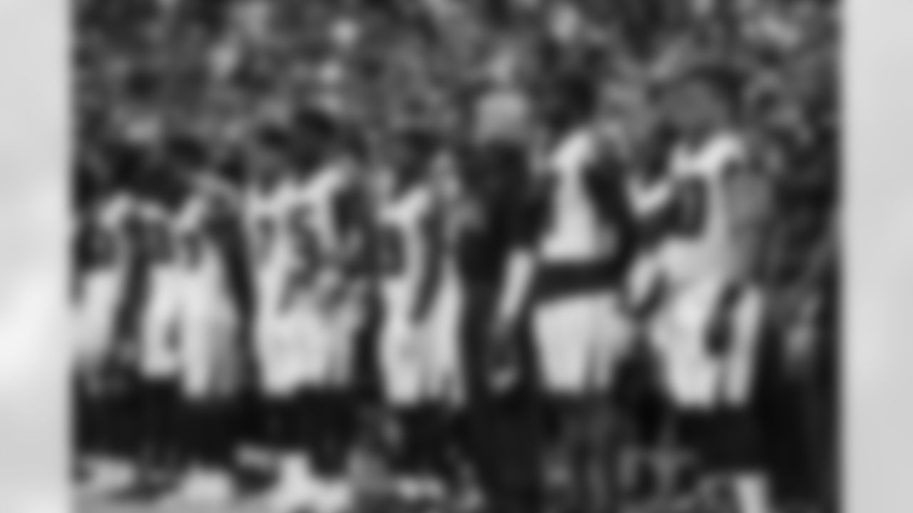 Dan Quinn, Head Coach stands alongside Falcons team for the National Anthem