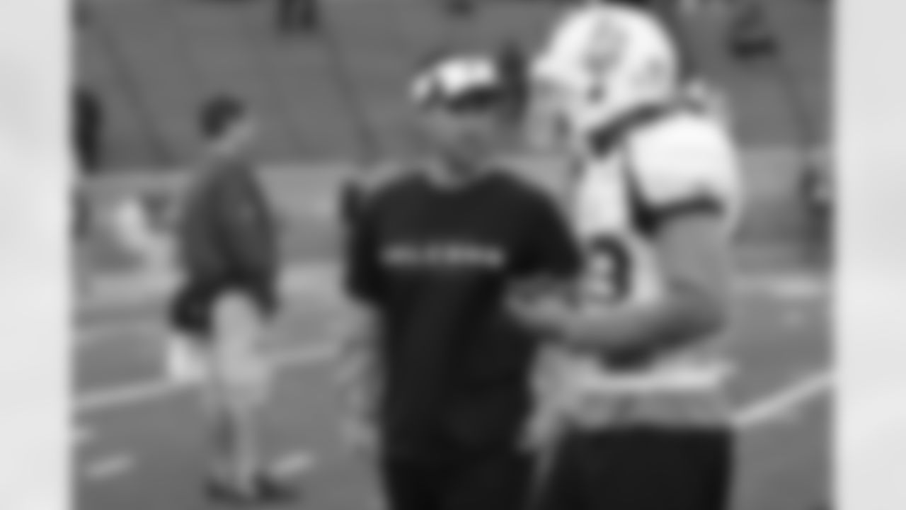 Falcons offensive assistant Andrew Weidinger works with Wyoming WR Robert Herron.