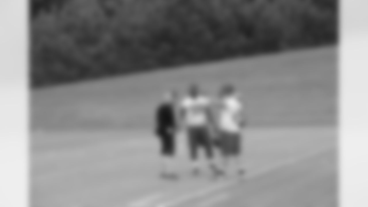 Jonathan Massaquoi (96) chats with assistant trainer Corey Gildea and LB Pat Schiller // 2012 Rookie Minicamp – Day 2 // May 12, 2012 // Flowery Branch –