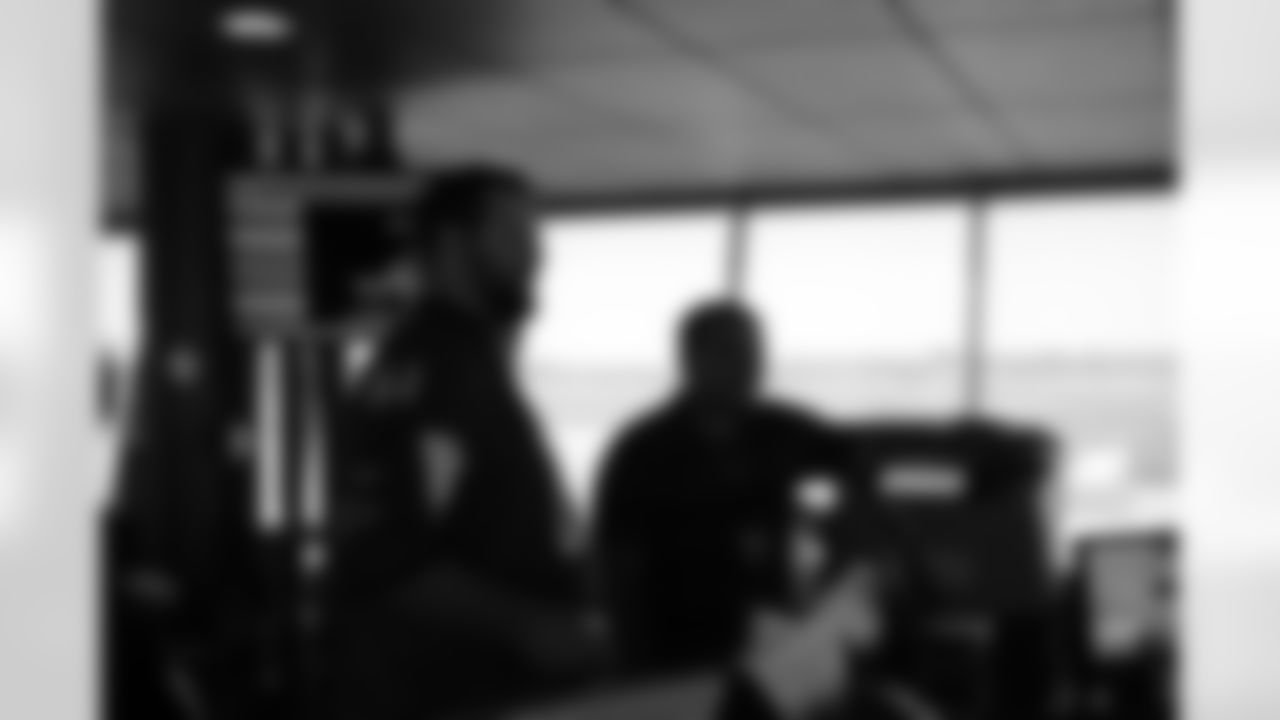 Several Falcons traded places with AirTran workers to marshal planes, take tickets and greet passengers // Trading Places - AirTran // Nov. 1, 2011 // Atlanta -