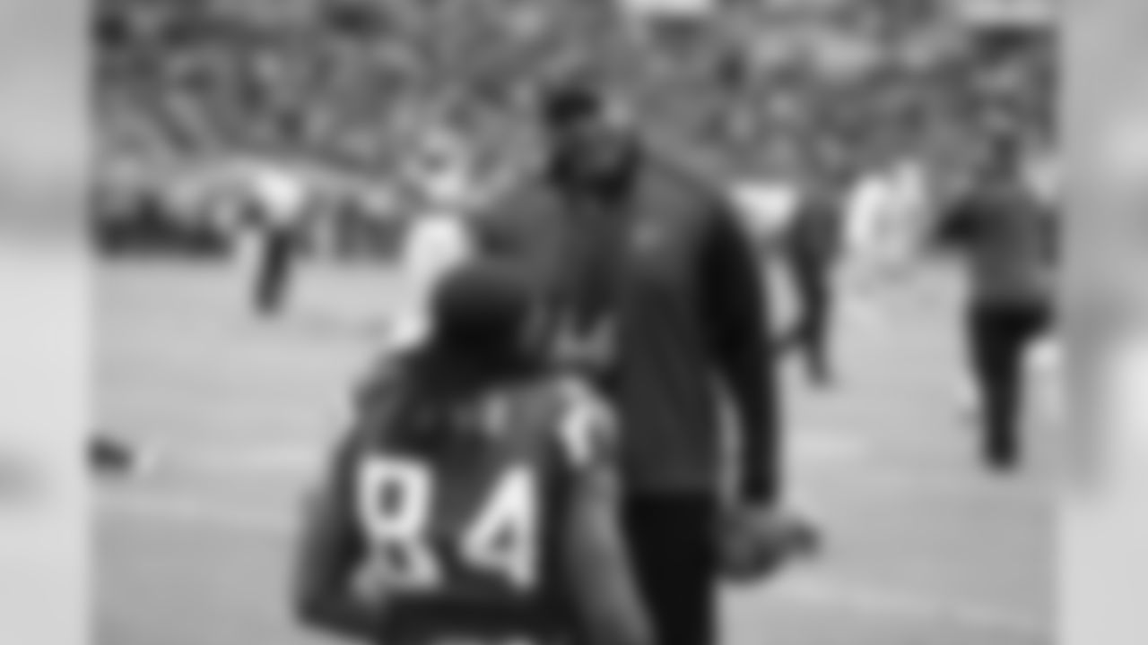 Gerald Brown, running backs coach, talks to WR Roddy White