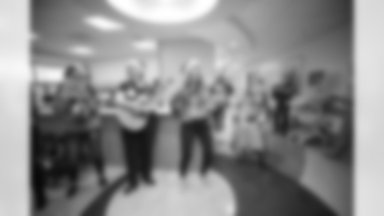 The Atlanta Falcons visited CHOA at Scottish Rite Hospital to sing carols with Santa and give autographed posters to the kids
