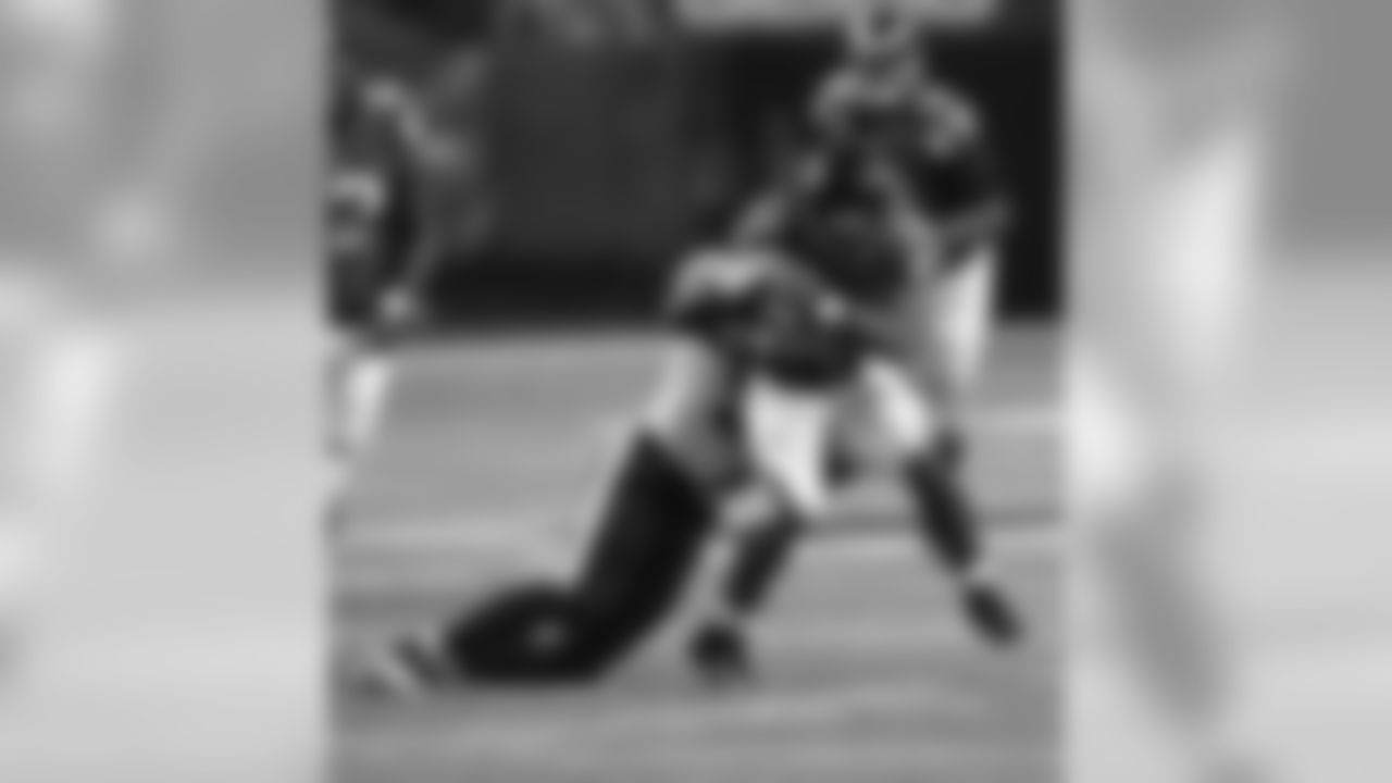 RB Devonta Freeman attempts to shake off a tackle during a run.