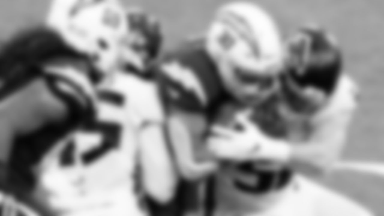 Atlanta Falcons tackle Los Angeles Chargers running back Austin Ekeler #30 during the third quarter against the Los Angeles Chargers on December 13, 2020.
