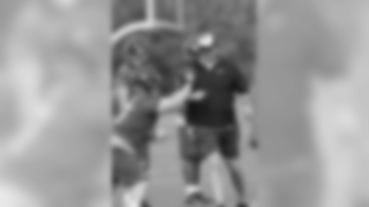 OL Adam Replogle pushes off of offensive line coach Mike Tice