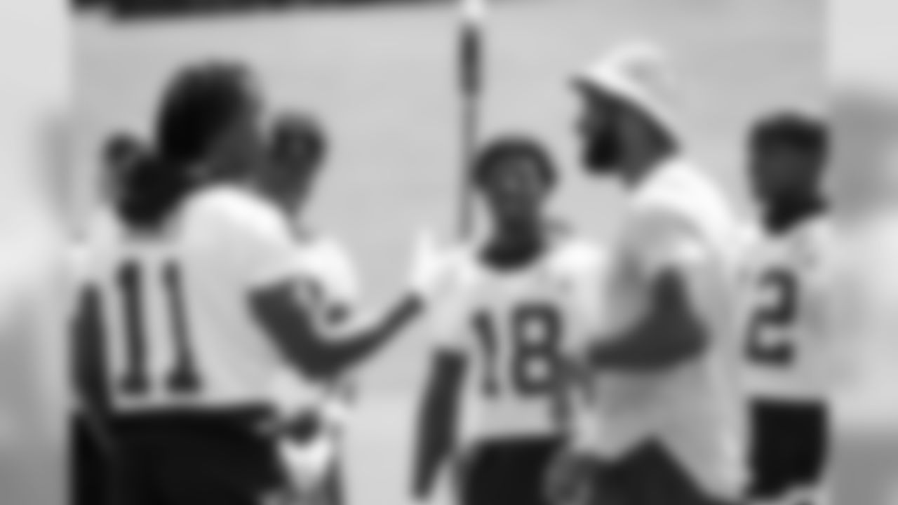Former NFL wide receiver Calvin Johnson talks to Falcons wide receivers
