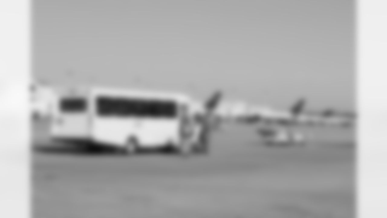 Several Falcons traded places with AirTran workers to marshal planes, take tickets and greet passengers // Trading Places - AirTran // Nov. 1, 2011 // Atlanta -