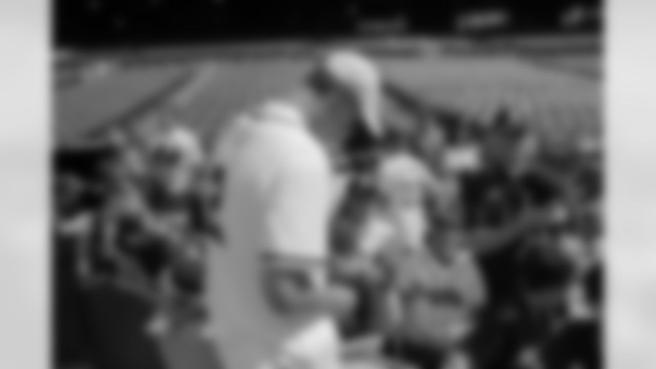 Matt Ryan takes a moment to sign autographs for some young fans before the