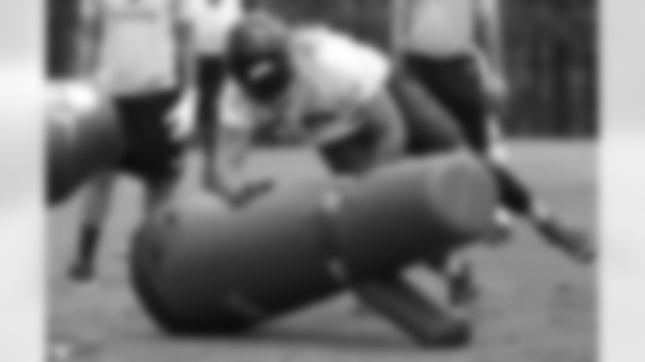 OLB Tyler Starr takes down a tackling dummy