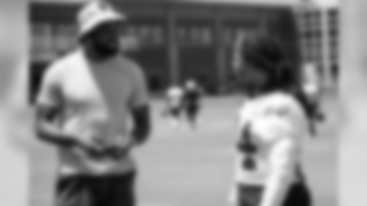 Former NFL wide receiver Calvin Johnson talks to Devonta Freeman