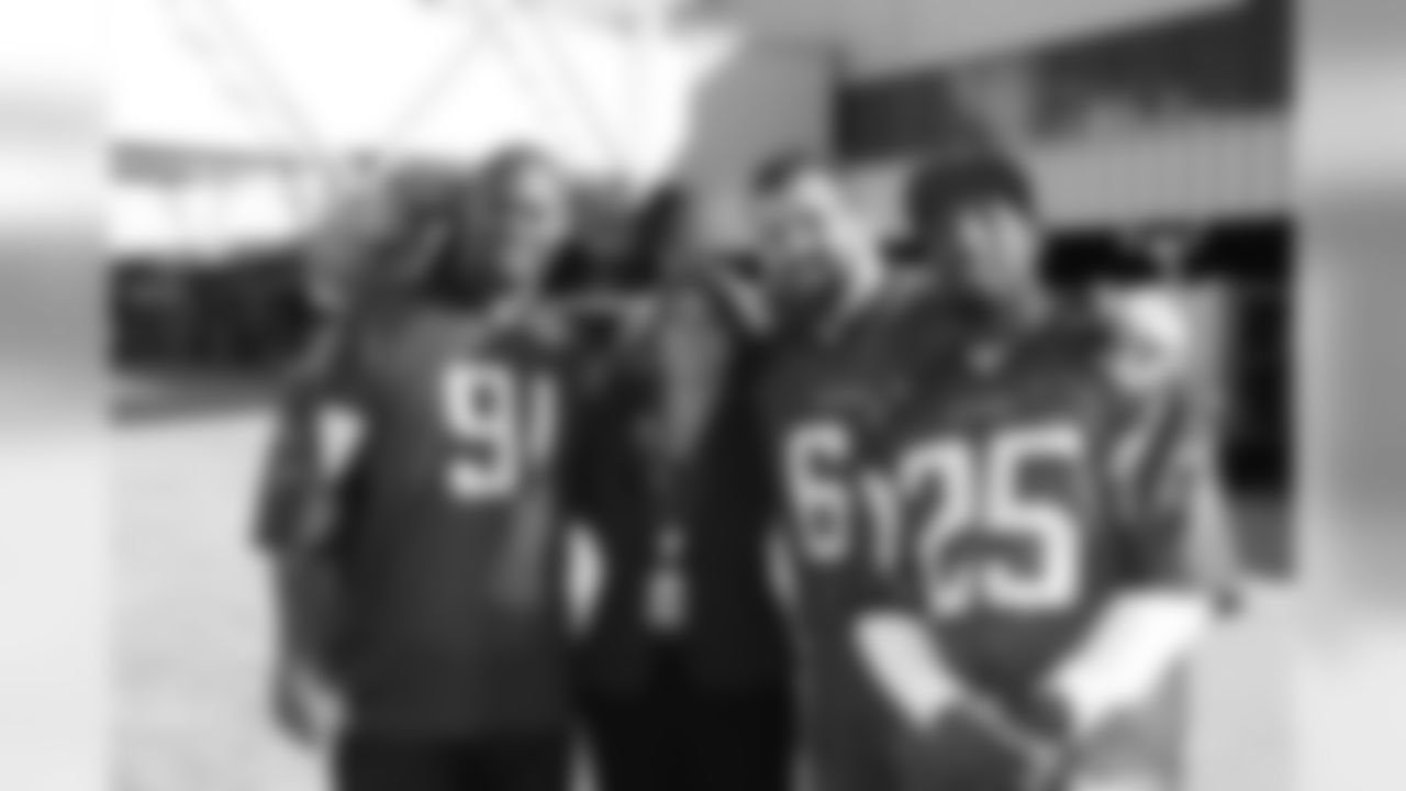 Several Falcons traded places with AirTran workers to marshal planes, take tickets and greet passengers // Trading Places - AirTran // Nov. 1, 2011 // Atlanta -