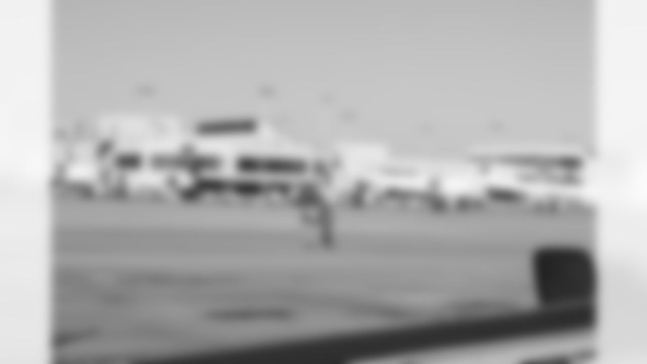Several Falcons traded places with AirTran workers to marshal planes, take tickets and greet passengers // Trading Places - AirTran // Nov. 1, 2011 // Atlanta -