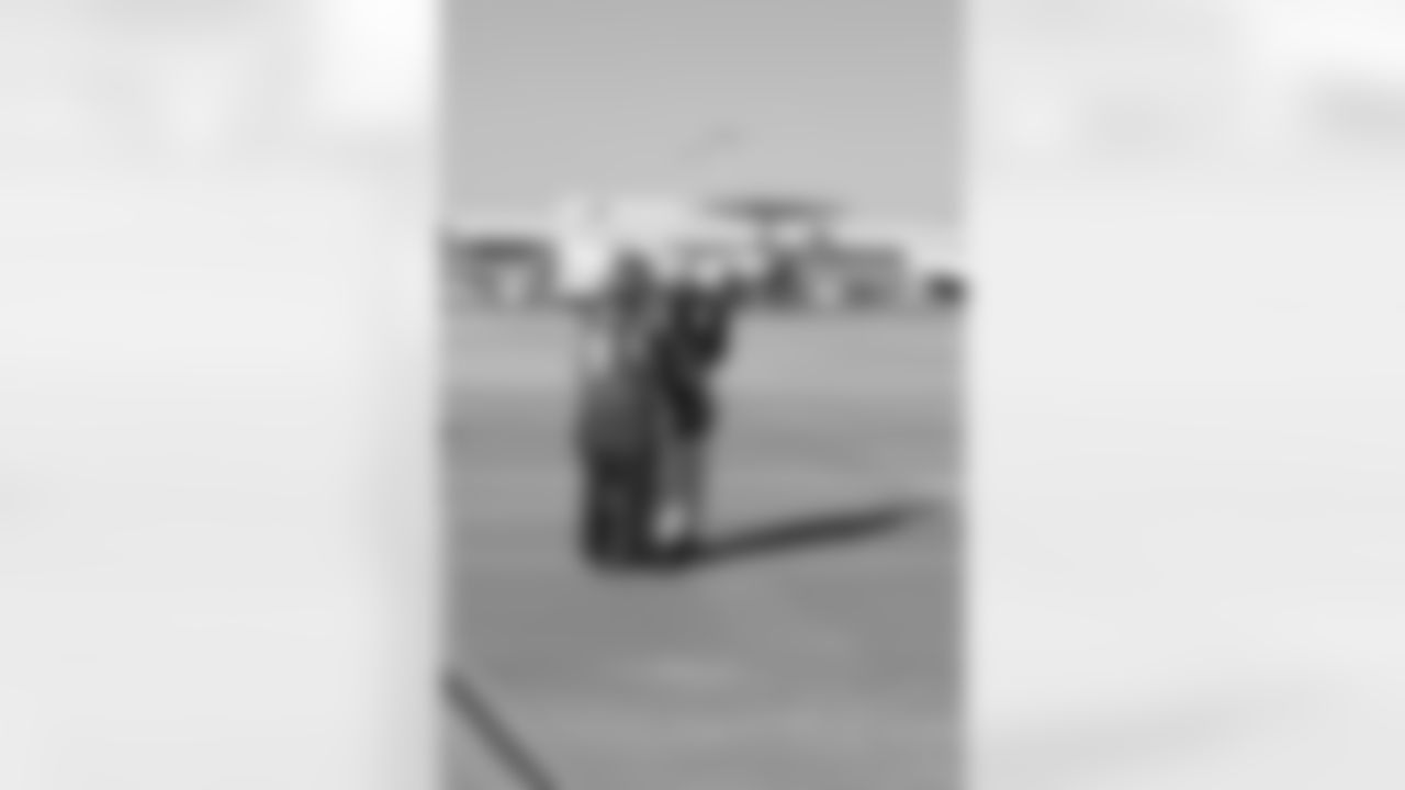 Several Falcons traded places with AirTran workers to marshal planes, take tickets and greet passengers // Trading Places - AirTran // Nov. 1, 2011 // Atlanta -