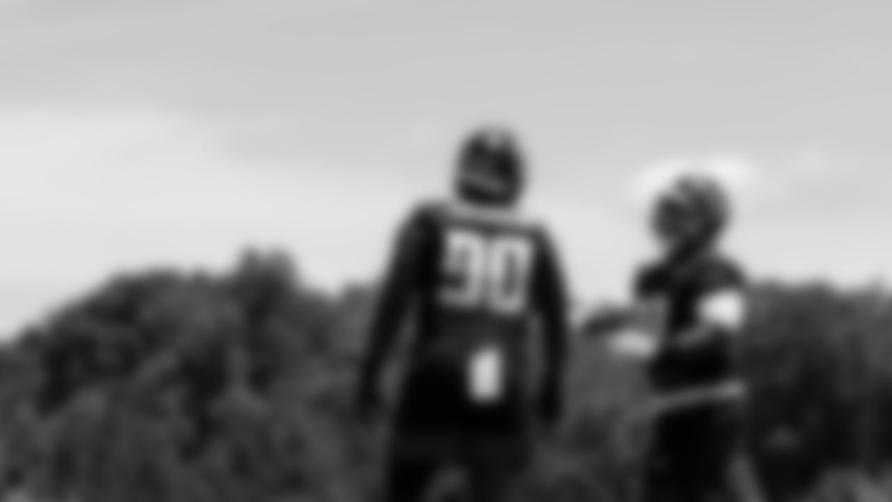 Atlanta Falcons defensive tackle Grady Jarrett #97 laughs with Atlanta Falcons defensive end Marlon Davidson #90 during organized team activities in Phase III of the Atlanta Falcons offseason program on June 4, 2021.