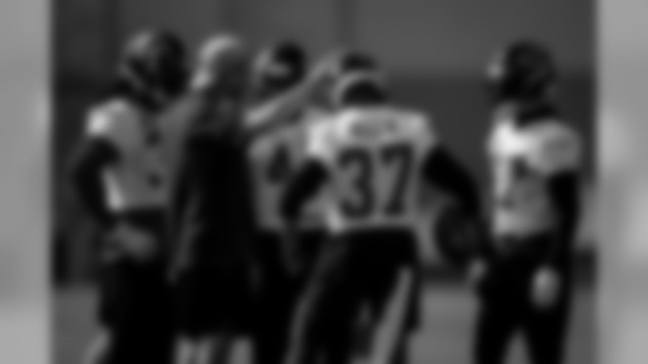 Coach Doug Mallory puts his hand on the head of Atlanta Falcons free safety Ricardo Allen #37 in a defensive back huddle during practice. (Photo by Kara Durrette/Atlanta Falcons)