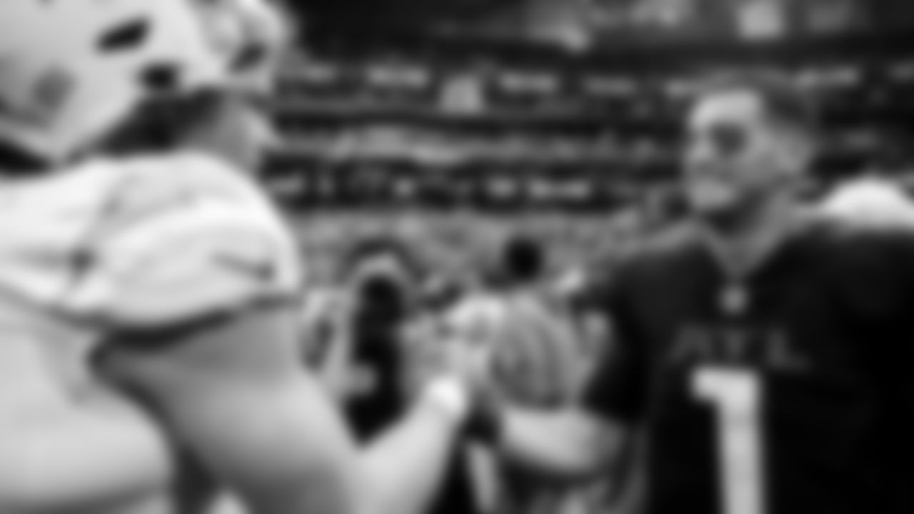 Atlanta Falcons quarterback Marcus Mariota #1 talks with Los Angeles Chargers quarterback Justin Herbert #10 after their game at Mercedes-Benz Stadium in Atlanta, Georgia on Sunday, November 6, 2022. (Photo by Brandon Magnus/Atlanta Falcons)