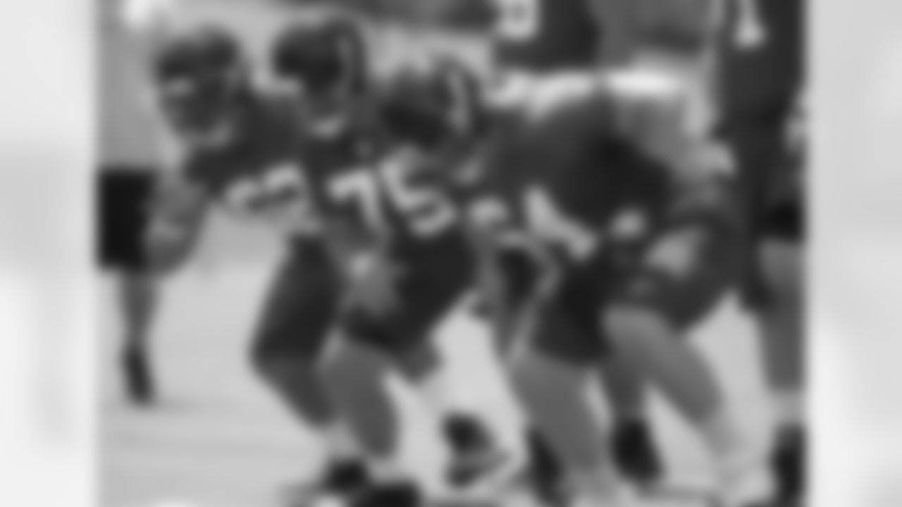 Offensive linemen work on technique in the few minutes before practice officially starts