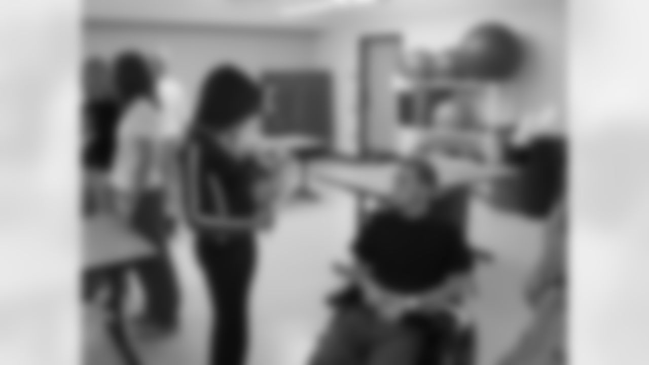 Cheerleader talks with patient.