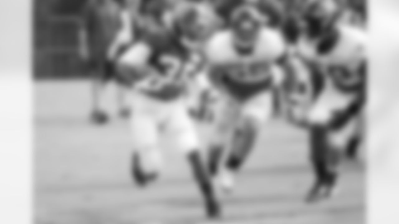 RB Antone Smith runs the ball past LB Paul Worrilow and LB Joplo Bartu