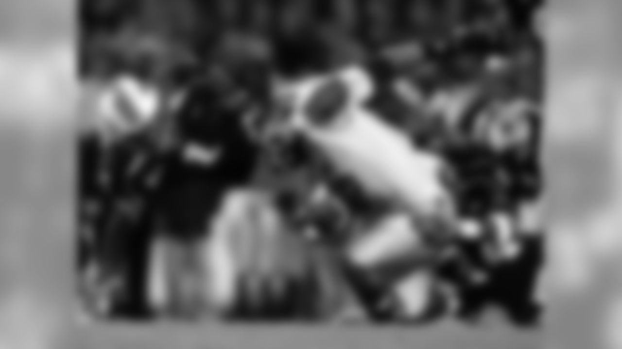 RB Antone Smith is tackled by a University of Maryland defensive player during a game in 2006.
