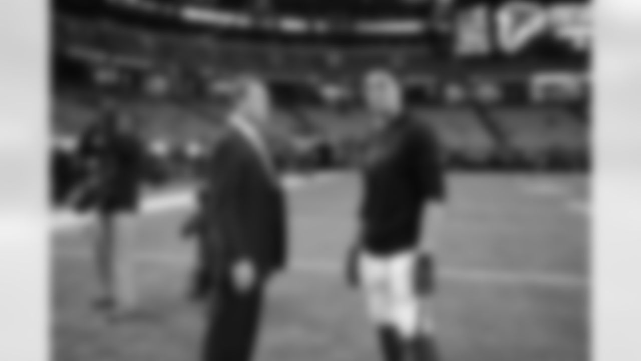 TE Tony Gonzalez catches up with former NFL player John Lynch before the game.