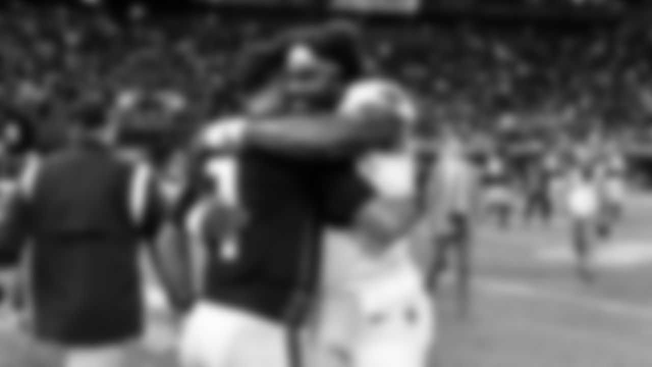Atlanta Falcons quarterback Marcus Mariota #1 hugs a New Orleans Saints player after the game against the New Orleans Saints at Mercedes-Benz Stadium in Atlanta, Georgia on Sunday, September 11, 2022. (Photo by Kyle Hess/Atlanta Falcons)