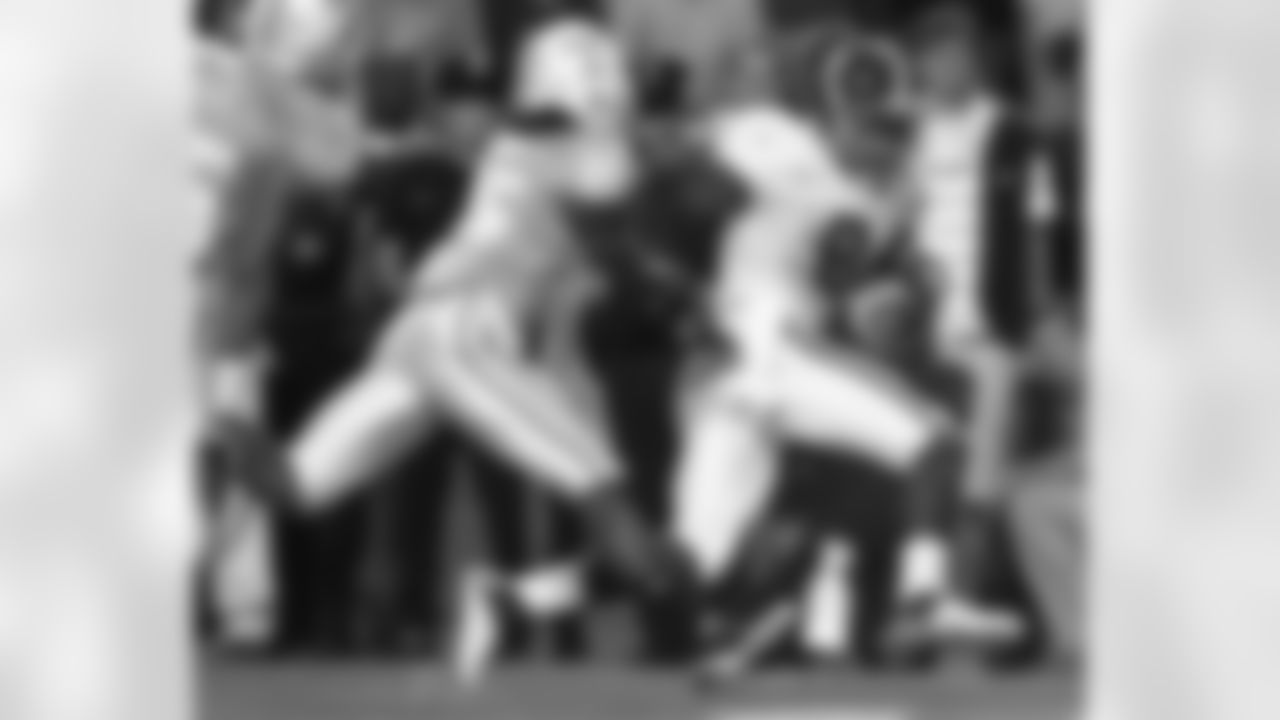 Julio Jones catches a pass as he tries to escape from Tennessee's Art Evans on October 23, 2010 in Knoxville, Tenn.