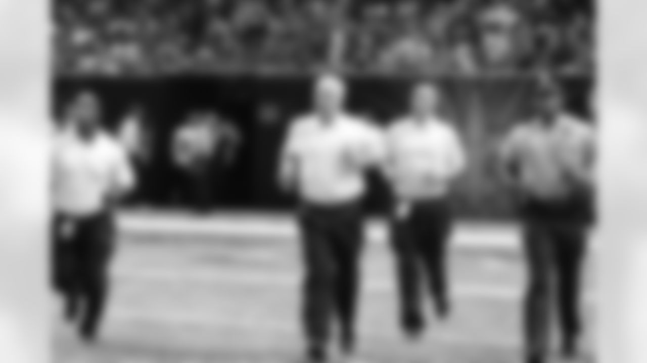 Head coach Mike Smith runs onto the field