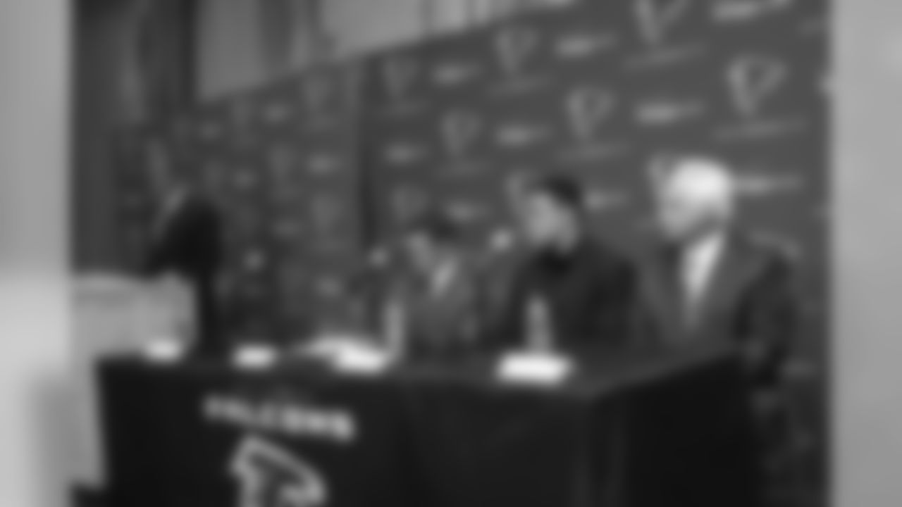 Tony Gonzalez sits with general manager Thomas Dimitroff to his right and head coach Mike Smith to his left while Falcons owner and chairman Arthur Blank speaks.