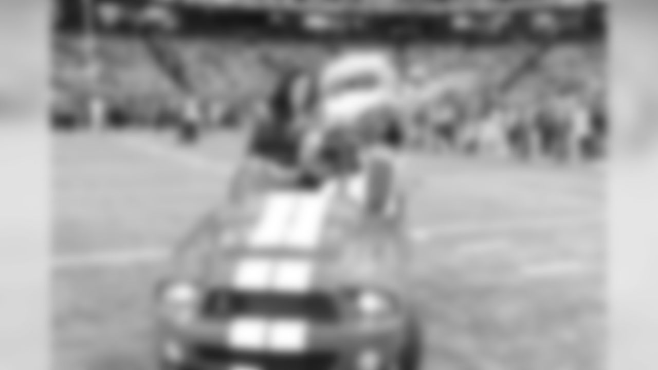Freddie Falcon takes a spin on the field before the game