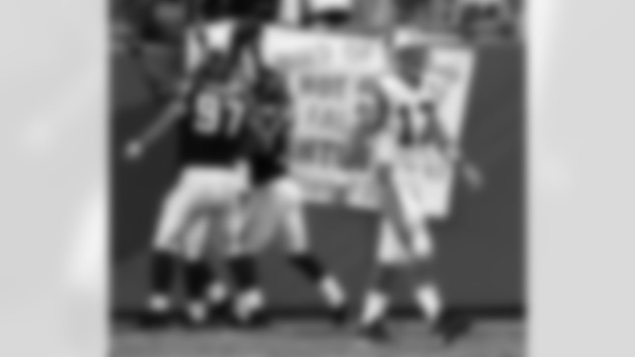 Carolina Panthers quarterback jake Delhomme (17) walks off the field as Atlanta Falcon's players Patrick Kerney (97) Jason Webster (36) and Kevin Mathis celebrate Mathis' 35-yard intercetion return for a touchdown in the fourht quarter of the Falcons' 27-10 win in Charlotte, N.C., Sunday Oct. 3, 2004. (AP Photo/Chuck Burton)