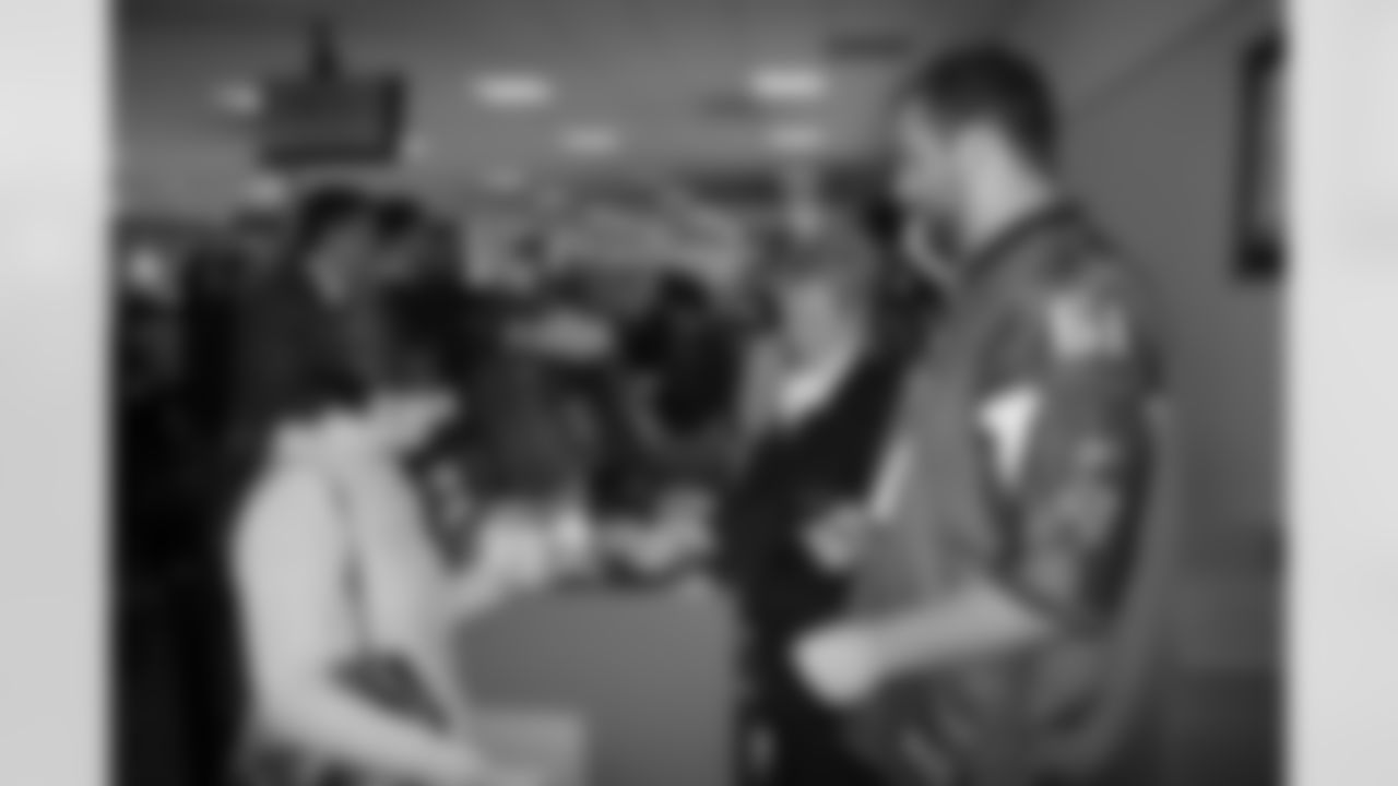 Several Falcons traded places with AirTran workers to marshal planes, take tickets and greet passengers // Trading Places - AirTran // Nov. 1, 2011 // Atlanta -