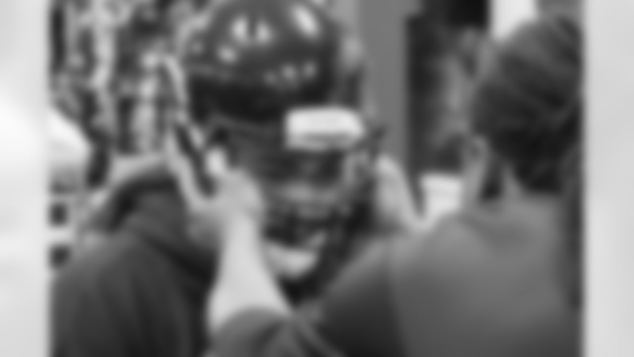 Fresno State offensive tackle Alex Fifita goes through final helmet checks