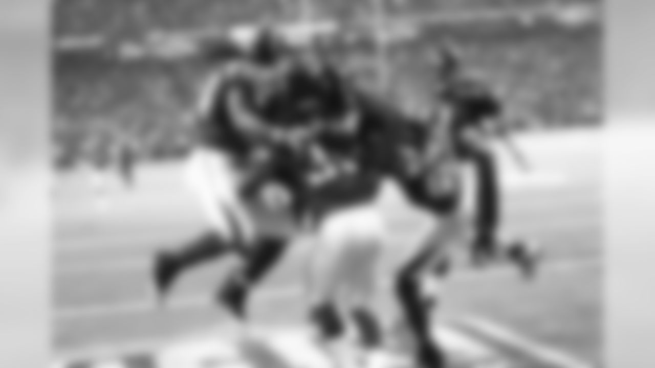 The team celebrates after RB Antone Smith scores a touchdown against the New Orleans Saints in Week 1.