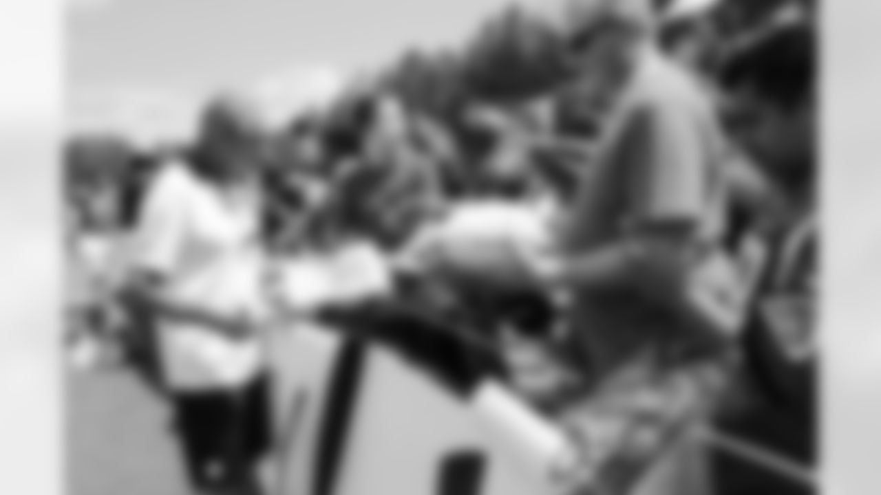 Falcons owner Arthur Blank signs autographs after practice